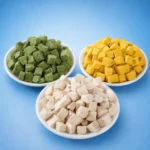Three bowls of green, yellow and white freeze-dried cubes shown in this pet food guide.