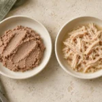 Pate vs shredded cat food in two shallow bowls, showing a smooth mash and distinct strands